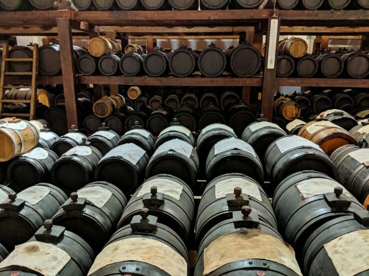 Numerous balsamic vinegar barrels in a storage room