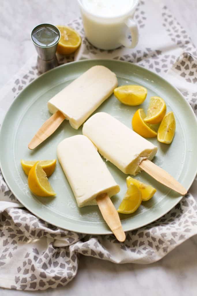Popsicles on a plate with lemons and cream