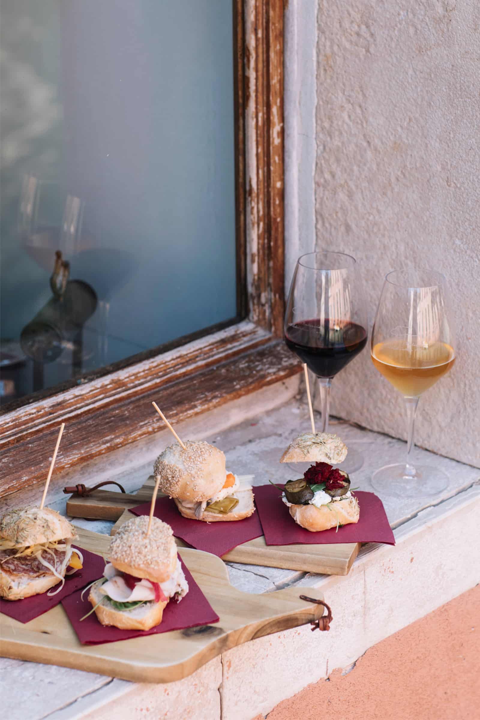 Glasses of wine and small sandwiches in window in Venice Italy