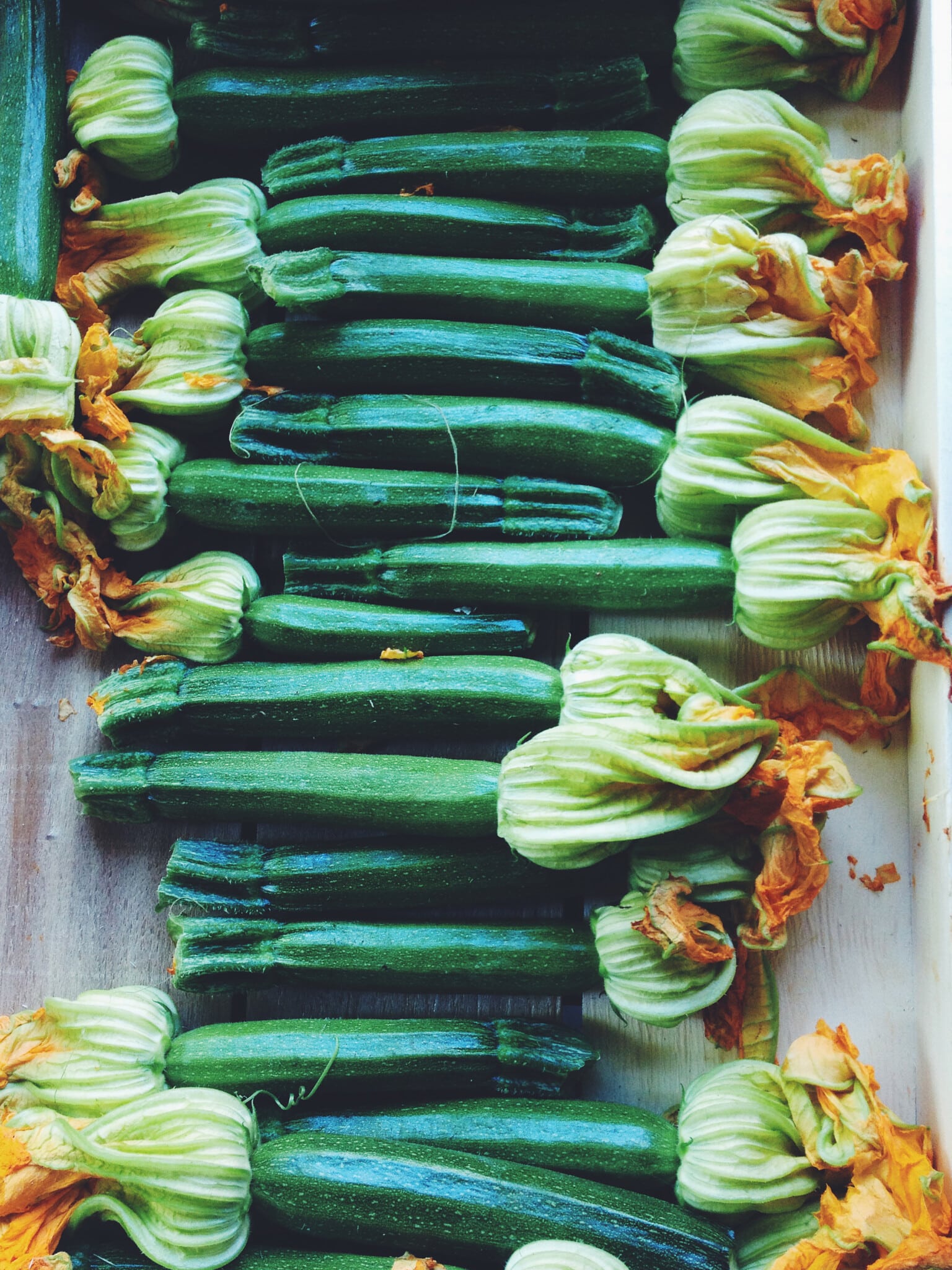 Zucchini With Flowers On End At A Market