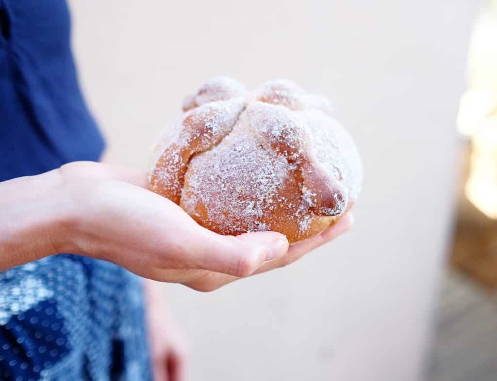 Person holding pan de muerto