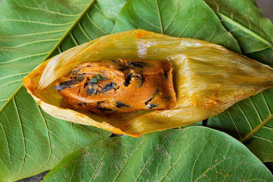 Oaxacan tamales with chiles on green leaves