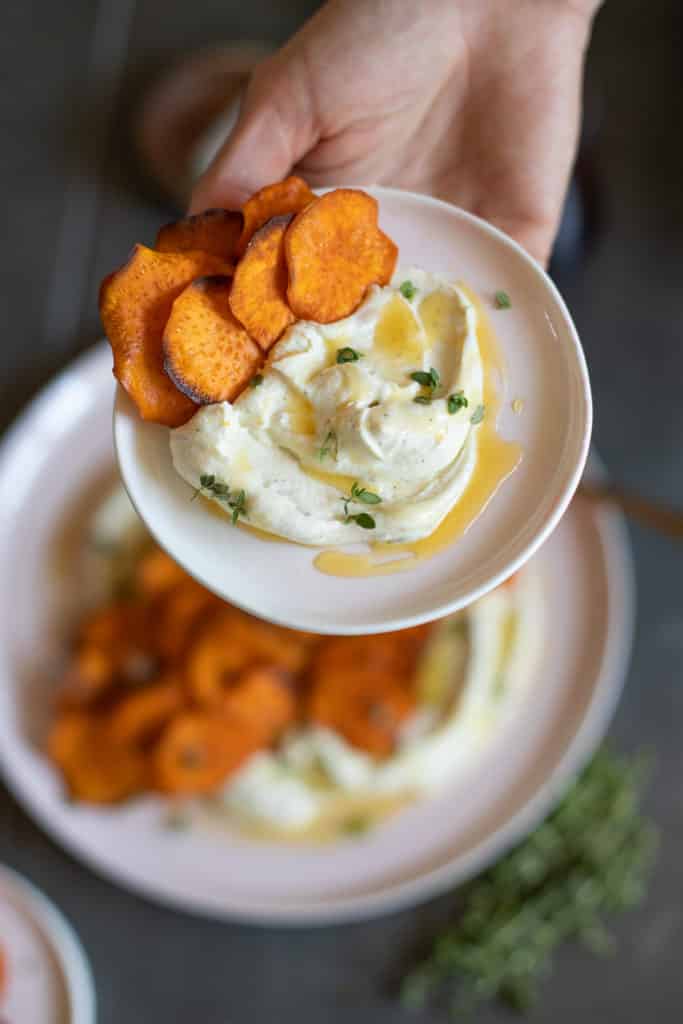 Small plate of whipped goat cheese with sweet potato chips