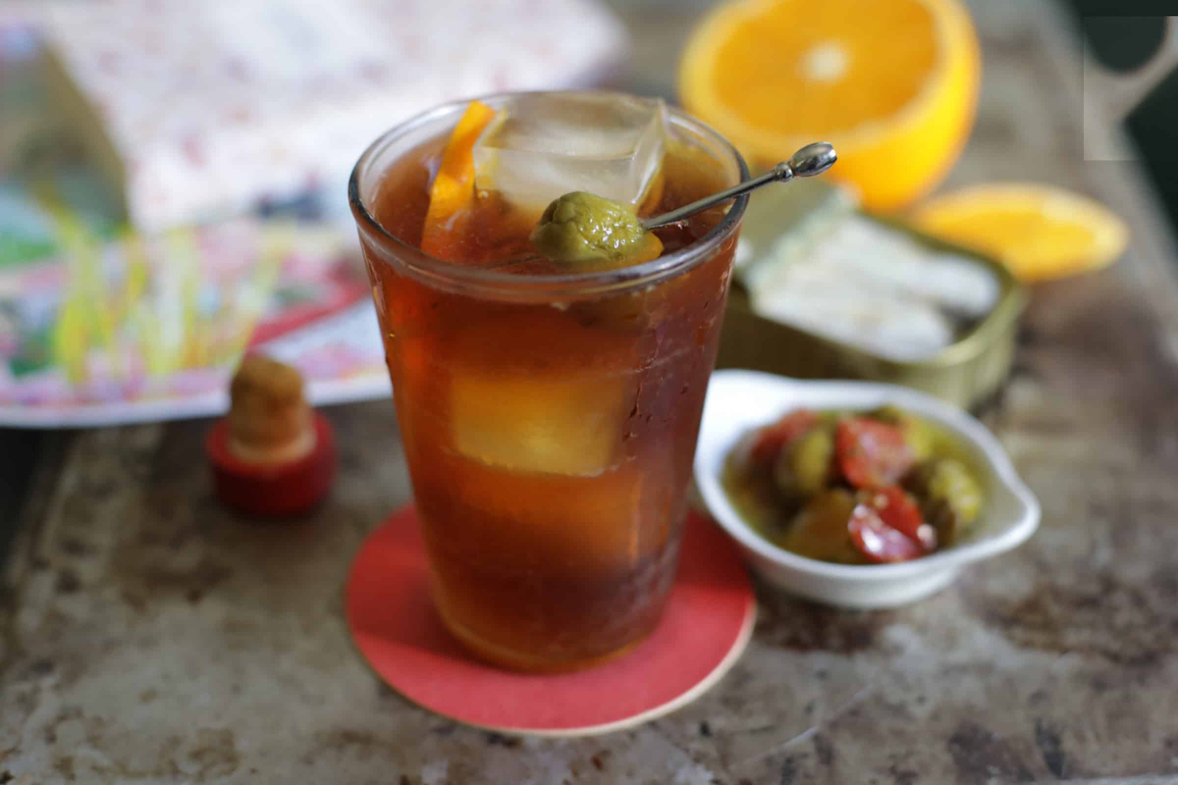Red Vermouth And Soda On A Table With Olives