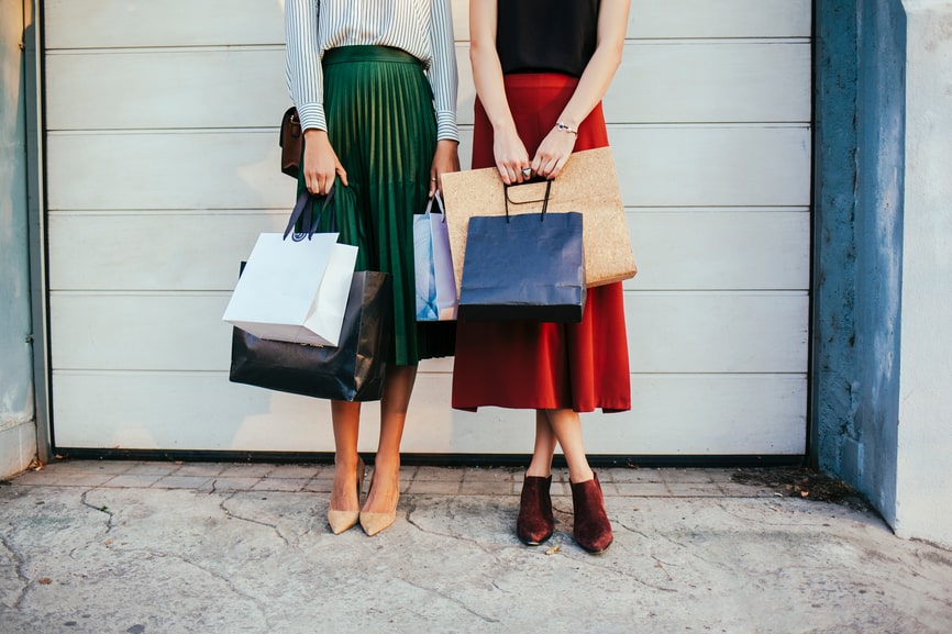 Women With Shopping Bags In Front Of A Garage