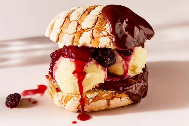 Concha filled with berries, ice cream, and chocolate sauce