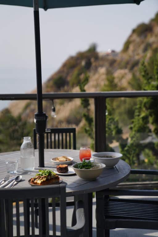 Food on a table with Big Sur view in background