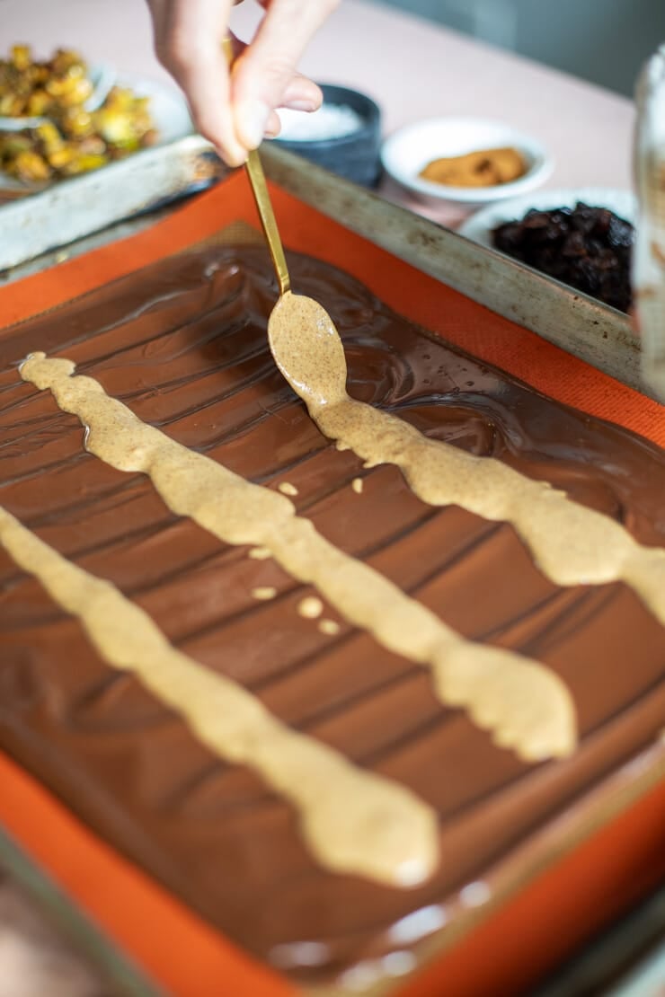 Peanut butter being drizzled on melted chocolate