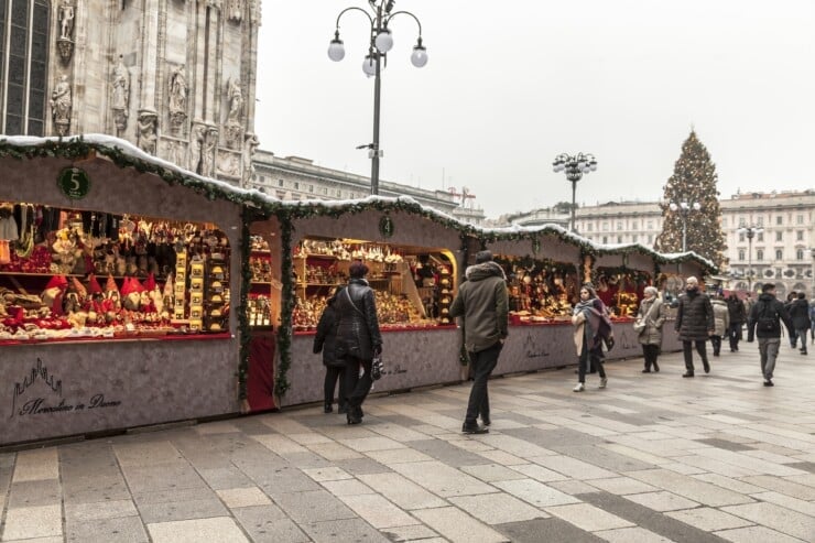 People walking by Christmas market stalls in Milan Italy