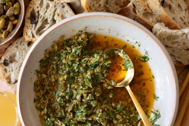 Close up bowl of Olive Dip with spoon in serving bowl