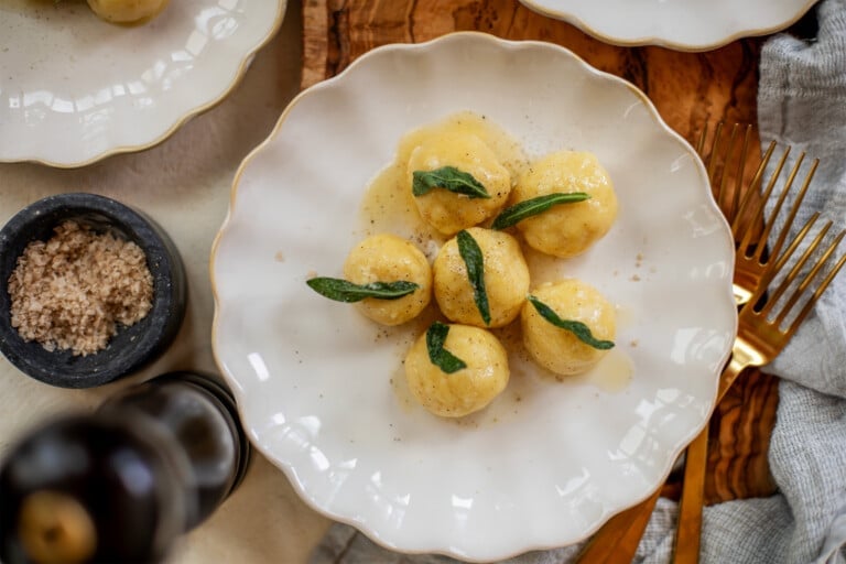 Plate of ricotta gnudi with salt and forks