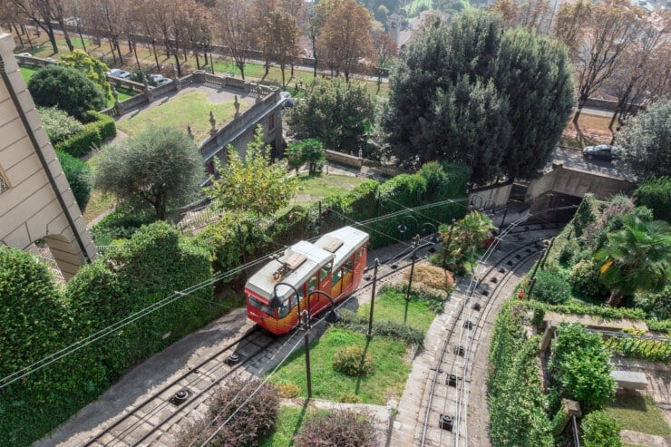 Funicular climbing hill with greenery around