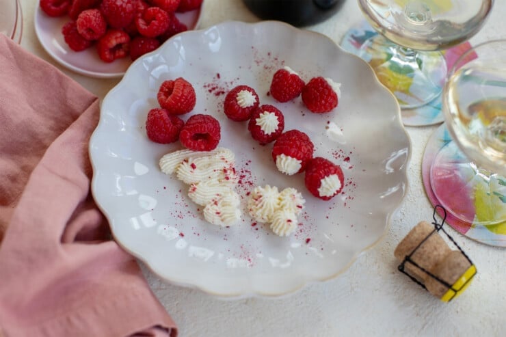 Plate with whipped Mascarpone cream and raspberries