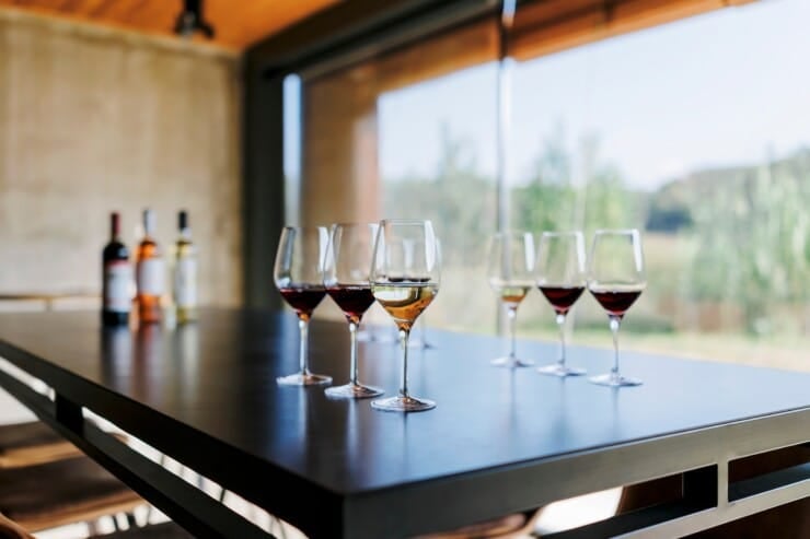 Glasses and wine bottles on table for wine tasting