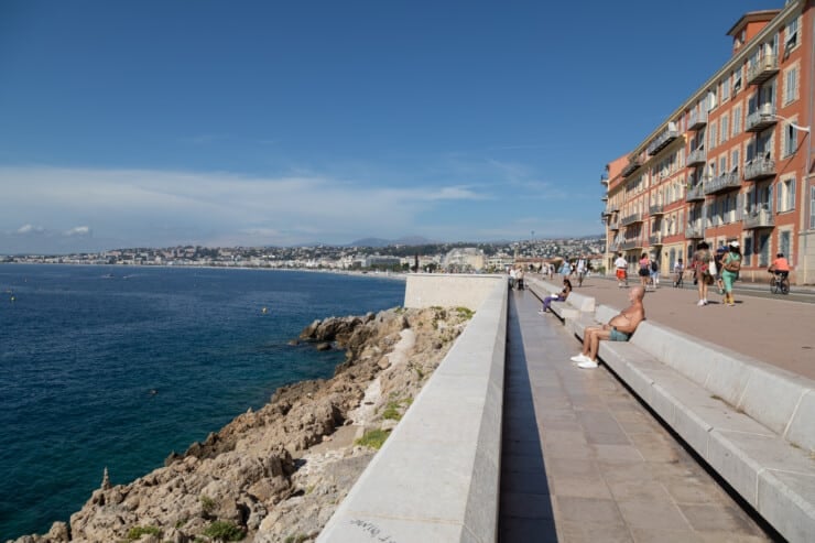 People resting along sea front promenade