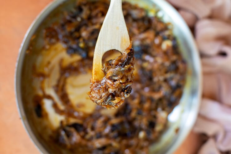 Closeup spoonful of jam over a pan